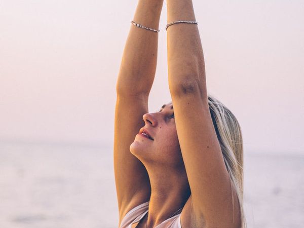 A serene person meditating outdoors at sunrise, embodying tranquility and inner peace.